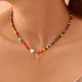 Rainbow bead necklace with white heart charm and gold letter S pendant on model - Letter A (A80008-A)