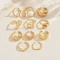 Detailed flat lay of 11 gold rings set with elegant pearls and textured metal designs - Vintage Minimalist Artificial Pearl Ring 11-Piece Set (JZ1464) / Gold