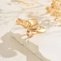 Detailed view of a gold irregular crumpled wing ring on a white stone background - Irregular Petal Shape Ring (SF367-2) / Gold