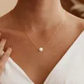 Detail of a gold paperclip chain necklace with a single white pearl pendant on a model - Paperclip Chain Single Pearl Pendant (AM80017-3)