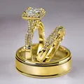 Three-piece gold plated ring set with princess cut zircon and twisted band in macro view - Gold Ring Set