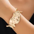 Golden liquid metal cuff bracelet featuring irregular texture and modern design - Bangle (2270) / Gold