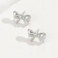 Close-up of elegant silver bow-knot earrings with a polished metallic mirror finish - Silver Symmetric Bow (BSSP008B)