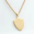Detail of a minimalist gold shield pendant with a smooth box chain in stainless steel - Pendant Only / Gold