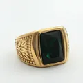 Detailed macro view of vintage gold ring featuring a large emerald-cut green gemstone - Gold Green