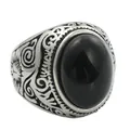 Macro shot of vintage titanium steel ring featuring an oval black stone and ornate carving - US 8 / Black Agate