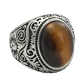 Close-up of vintage steel ring with oval tiger eye stone and intricate carvings - US 7 / Tiger's Eye