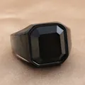 Macro shot of vintage black stainless steel ring with emerald-cut black gemstone - Matte Black Black Gemstone Style