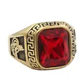 Macro detail of gold-plated punk ring with a large red stone and Greek key pattern - US 7 / Gold Red Stone