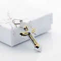 Detail of two-tone layered cross pendant with wings on polished stainless steel base - Gold And Silver Two-Tone Cross Wing Style / Gold