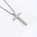 Polished silver stainless steel cross pendant necklace with box chain on white steps - Silver Large