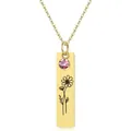 Macro view of gold rectangle pendant with pink gemstone and engraved daisy flower - October - Cosmos