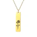 Close-up of golden rectangular bar pendant with fine flower engraving on a thin chain - Floral Botanical Style (9)