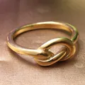 Vintage punk style titanium steel gold knot ring with polished finish on silk background - US 6 / Gold