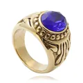 Macro detail of retro gold titanium steel ring with a large faceted blue gemstone inlay - US 8 / Gold Blue Stone