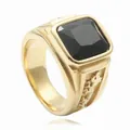 Close-up of men's gold signet ring featuring a large square black stone and embossed side - Gold Black