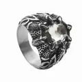 Macro shot of gothic silver dragon claw ring holding a faceted clear crystal stone - Antique Silver White