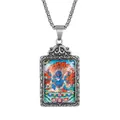 Close-up of Mahakala pendant with colored thangka deity art and embossed metal frame - Blue Mahakala Pendant Only (Without Chain)