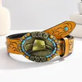 Detail of western cowboy leather belt featuring embossed floral patterns and turquoise buckle - 105cm / Ginger Yellow