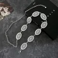 Vintage western silver metal waist chain with engraved oval links on dark stone background - Silver