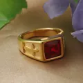 Close-up of vintage gold stainless steel ring with square red stone and cross relief - Gold Red Stone