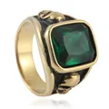 Vintage punk skull ring in gold with a large emerald green gemstone and gothic relief - Gold Green Stone