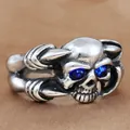 Detailed macro view of vintage skull ring with blue gemstones and punk steel finish - Size 7 / Silver-Blue Eyes