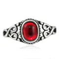Macro shot of vintage titanium steel ring with red oval stone and hollowed heart details - US 7 / Silver With Red Stone