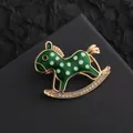 Close-up of a green enamel rocking horse brooch with gold accents and sparkling rhinestones - Green Rocking Horse (XZ268 Rocking Horse Green)