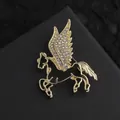 Detailed macro view of a gold-plated Pegasus brooch with white rhinestones on black leather - Gold Hollow Pegasus (XZ09-022 Gold)