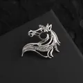 Detailed close-up of a silver horse head brooch with sparkling white and black rhinestones - Silver