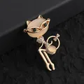 Close-up of golden cat brooch with cat's eye stones and sparkling white rhinestones - Gold Cat