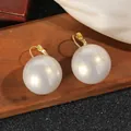 Detailed view of large pearl drop earrings with elegant gold hooks on silk fabric - 2.5cm Style / White