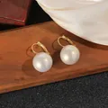 Macro view of large white pearls on golden lever-back earrings with silk background - 1.8cm Style / White