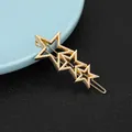 Detailed close-up of golden alloy star hair clip with three hollow stars and polished finish - Meteor Triple Star Style