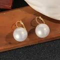 Close-up of elegant large white pearl ear buckle earrings on wooden background - 2.0cm Style / White