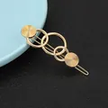 Close-up of golden geometric cat hair clip with concentric circle engraving on leather - Concentric Circle Geometric Style