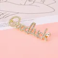 Detail of gold Goodluck brooch with micro-pave crystals and a teardrop gemstone - Goodluck Style / Gold