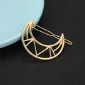 Detail view of a hollow moon-shaped golden alloy hair clip with a polished finish - Geometric Crescent Style