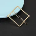 Close-up of geometric square gold hair clip with minimalist metal clamp design - Square Geometric Style