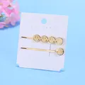 Set di fermagli per capelli dorati con sorrisi traforati in metallo su carta - Set Sorriso