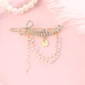 Elegante pinza dorada con brillantes diamantes de imitación y borlas de perlas - Estilo Lazo