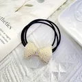 Close-up of elegant hair tie with pearl-encrusted bow and sparkling rhinestone details - Dense Cluster Pearl Bow (Style 4)