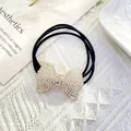 Detailed view of a black elastic hair tie with a sparkling rhinestone bow and AB crystals - Full Rhinestone Bow (Style 5)