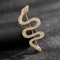 Macro view of gold snake brooch with sparkling white crystals on textured black background - Gold Style XZ66-002
