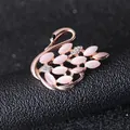 Close-up of rose gold swan brooch with pink cat eye stone and sparkling crystals - Cat's Eye Swan