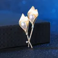 Detailed view of elegant gold Calla Lily brooch with white pearls and sparkling crystals - Golden Calla Lily