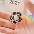 Elegant black camellia brooch with white faux pearls and gold plating finish - Pearl Camellia / Camellia Black