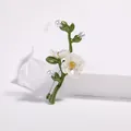 Elegant green floral brooch with white pearls and enamel finish on minimalist pedestal - Flower Motif Style