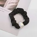 Elegant black scrunchie with iridescent pearl charm and gold border for elegant hairstyles - Square